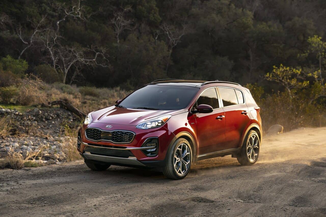 Image for a Can a Kia Sportage be flat towed? Shows a red Kia Sportage driving across a dusty road
