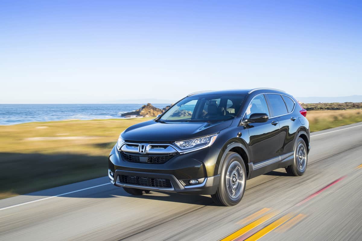 Image for "can you drive a Honda CR-V without a driveshaft?" shows a 2017 honda CR-V driving in front of the ocean