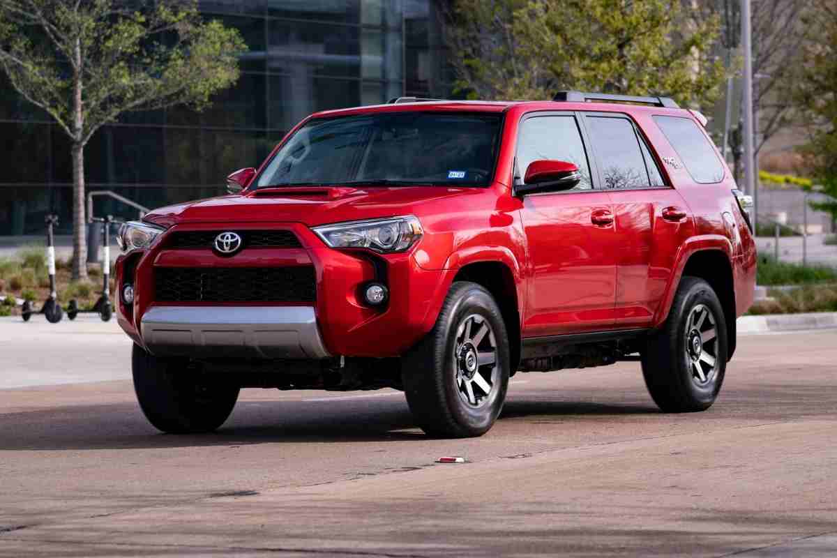 Image for: 5 Reasons Toyota 4Runners Are Easy to Steal and How To Fix It! Shows a red Toyota 4Runner parked in an urban environment. 