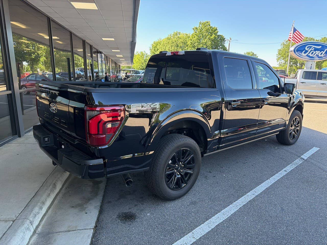Biggest Tires On A Stock Ford F-150: What Owners Report 2 side angle of Kern's new 2025 Ford F150 Platinum edition purchased at Capital Ford in Raleigh NC