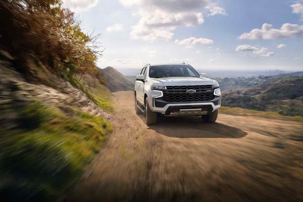 Image for best and worst chevy tahoe years shows a white Chevy Tahoe traversing a dusty path