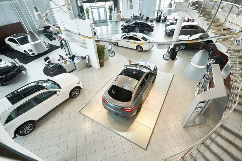 Image for: Buying a car with cash shows a luxury dealership with several cars