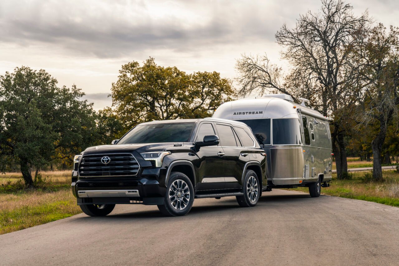 Image for "Toyota Sequoia Capacity By Year", shows a black Toyota Sequoia towing a trailer