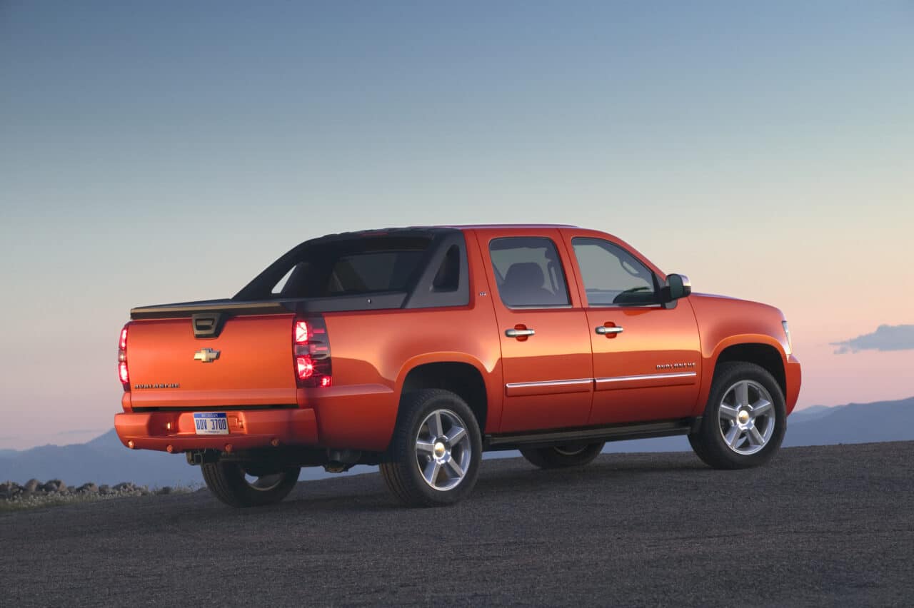 What Is the Best Year for the Chevy Avalanche?
The Chevrolet Avalanche is a five or six-passenger, four-door pick-up truck that saw discontinuation in 2013 after 12 years. This vehicle is the perfect cross between the SUV and truck. Over the 12 years, there were two generations of the Chevy Avalanche- the 1st from 2002-2006, and the 2nd from 2007-2013. But, which of the years is the best?

This article delves deep into the best year of the Chevy Avalanche. Read on to know which and why it’s our pick.
What Is the Best Year for the Chevy Avalanche?
The best year of the Chevy Avalanche was 2013- which is still the last year for the Avalanche. Contrary to most people's belief, the discontinuation was not mainly due to poor sales. Although this is partly true, a bad business plan, loyal buyers of the Sierra and Silverado, and GM bankruptcy problems were the major cause of the discontinuation.

The 2013 Chevy Avalanche discontinuation wasn't because customers didn’t like the vehicle anymore. In fact, people were impressed by the vehicle combining the cargo bed space of a Silverado and the seating availability of a Tahoe and converting it into one.
How Did the 2013 Chevy Avalanche Fare vs. Competition?
Apart from this vehicle’s twin brother, the Cadillac Escalade, no other vehicle in this class made the use of a fold-down midgate available.

It’s worth noting that almost all new SUVs, crossovers, and trucks feature fold-down rear seats. However, none allows access to the vehicle’s bed through the cab. This makes the cargo space in the 2013 Chevy Avalanche quite big. With such a supersize, you’re open to options you’ll never get with other vehicles.

The main competitors of the 2013 Chevy Avalanche are:

Toyota Tundra
Honda Ridgeline
Ram
Ford F150
Nissan Titan

Trim Models for the 2013 Chevy Avalanche
There’s no doubt the 2013 Chevy Avalanche is the best year for the Chevy Avalanche. On top of giving this vehicle the boot, GM ensured to improve it in several areas, adding some zing to it. Trim models for the vehicle include the LS, LT, and the LTZ, which come with an offload Z71 package.

The Z71 package includes:

18-inch wheels
Tubular assist steps
Monotube shock absorbers
High-capacity air cleaner
Color-matched fender flares
Skid plates.

Of course, the 2013 Chevy Avalanche was the last model of the Avalanche before cancellation. All models featured a “Black Diamond Avalanche” badge to commemorate its success. 

In addition, the models had unique body-color bed surrounds, not seen in any other previous years.

The 2013 Chevy Avalanche includes a set of new standard features as well. These include:

Remote start.
Power adjustable paddles
Backup camera
Fog lights
Rear parking sensors
Exterior Highlights of the 2013 Chevy Avalanche
The Avalanche doesn’t shy away from flaunting its unique personality. Remember, this is neither a four-door pick-up nor a run-off-the-mill truck, but both. Unique, right? All of Chevy’s truck-based models come with front-end styling. This bold but familiar styling is available in the 2013 Chevy Avalanche.

If we can set the vehicle apart, you’ll realize it has sails connecting the cab to the bed. These emphasize the exterior length and the smooth roofline.

However, there’s a problem with the vehicle’s design-rearward visibility. The poor rearward visibility can make backing up and parking in tight spots pretty tough. Luckily, the vehicle has a backup camera and standard parking sensors that come in handy.

Exterior features of the 2013 Chevy Avalanche include:

Fog lights
Standard 17-inch wheels. Also, 18-inch or 20-inch wheels are available.
Available power-articulating running boards
Wraparound front bumper cover: It blends with the body nicely.
Interior Highlights of the 2013 Chevy Avalanche 
There’s no other category that the 2013 Chevy Avalanche shines more than the amenities and style of its interior. This truck can accommodate up to six individuals. It also has a standard upholstery, with leather being optional.

Interior features include:

Standard air conditioning
Midgate design allows for supersize cargo capacity
Available rear-seat entertainment system
Standard CD stereo
Available cooled and heated seats
Standard Bluetooth connectivity 
An available touch-screen navigation system
Under the Hood Highlights of the 2013 Chevy Avalanche
The 2013 Chevy Avalanche is quite powerful. It’s powered by a 320-hp, 5.3-liter V-8, generating 335 pounds-feet of torque. Its mechanical features include:

Rear/four-wheel drive
Standard six-speed automatic transmission
V-8 operates on regular gas, although it can also run on E85 ethanol.
Safety Highlights of the 2013 Chevy Avalanche
Of course, we've mentioned some of the safety features of the 2013 Chevy Avalanche in this article. 

They may not be new, but quite vital to the Chevy Avalanche’s constant good safety ratings. The vehicle uses a StabiliTrak stability control system. This includes a hill start assist, and electronic trailer sway control. Other safety features include:

Side curtain airbags
Side-impact airbags (for the front seats)
All-disc anti-lock brakes
Rear-parking Assist with an Ultrasonic audible warning system
Automatic Crash Response
Stolen Vehicle Assist
Daytime Running Lamps with Automatic Exterior Lamp Control
LATCH system (Lower Anchors and Top Tethers for Children): for kids’ safety seats
Tire Pressure Monitoring System
Passenger Sensing System
Cargo Dimensions
The 2013 Chevy Avalanche, though not technically a truck, has greater cargo bed length than several of its truck competitors. The length of the cargo bed is 63.3 inches. The midgate is folded in the cargo bed’s upright position and 98.20 inches folded in its downside position. The total cubic space area equals 45 feet of cargo volume.
What Other Features Make the 2013 Chevy Avalanche the Best Year?
The 2013 Chevy Avalanche trailing equipment features a VR4 2-inch receiver, a hitch platform, and a 7-wire harness. The wire harness has independent fused trailering circuits that connect to a 7-way sealed connector.

Furthermore, the StabiliTrak adds to the vehicle’s trailing abilities. This way, the truck/SUV can tow at least one car, motor, or Uhaul safely home, not forgetting up to six people. Quite reliable!

The good news is that the 2013 Chevy Avalanche comes with automatic leveling control. This deals with any swagging in the rear with heavier cargo or loads.
Average Pricing for the 2013 Chevy Avalanche
You can get a 2013 Chevy Avalanche at an average price ranging from around $20,900 to about $33,500. The lowest price is for the base two-wheel-drive LS model, while the highest price tag is for the four-wheel-drive LTZ model.

Of course, you can expect the price to vary from one dealership and owner to another. Moreover, the price will vary depending on the vehicle's shape, location of sale in the US, and mileage.
The Insurance Cost
The insurance cost of a 2013 Chevy Avalanche will vary depending on several factors. These include:

Type of coverage
The insurance company
The deductible you choose

Notably, the 2013 Chevy Avalanche does pretty well with most insurers, thanks to its fairly safe features.
Why the 2013 Chevy Avalanche?
One may wonder why we picked the 2013 Chevy Avalanche as the best year. Of course, there are plenty of reasons. First, the model comes with the most up-to-date features. Additionally, the vehicle is available at a reasonable price. In fact, the vehicle is worth every penny, and you can never go wrong.

Go back to the previous years, and if you keep going a few years back, you’ll get an Avalanche with fewer safety features and more mile coverage. Undoubtedly, you cannot compare features of 2003, 2007, or even the immediate former (2012) with the last model of the Avalanche before discontinuation. The 2013 Chevy Avalanche wins and will always be the best.

It’s worth mentioning that the Chevy Avalanche received high ratings from experts and consumers even in its early years. Let’s hope the vehicle can probably make a comeback in the future.
