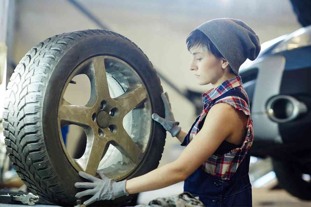image for: HOW MUCH DOES DISCOUNT TIRE CHARGE TO INSTALL TIRES? shows a female mechanic working on a tire