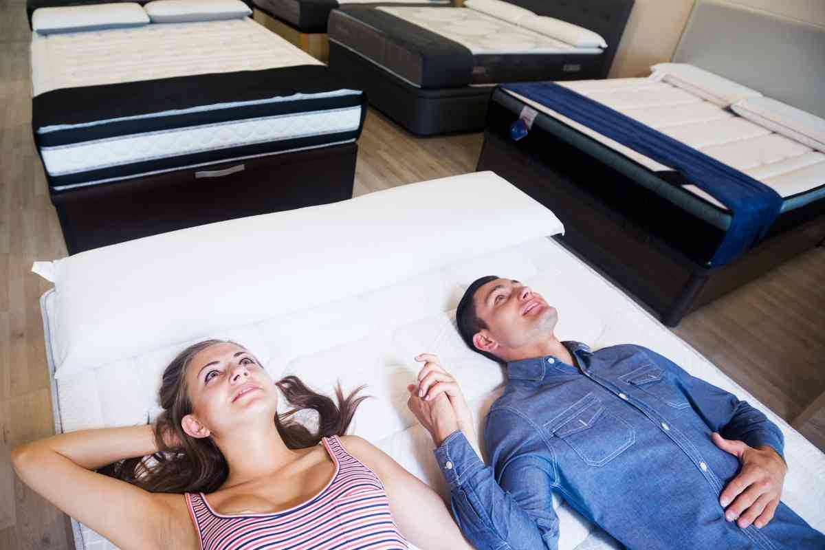 Generic image of a couple testing a mattress for the article "will a queen mattress fit in a Jeep Grand Cherokee?"
