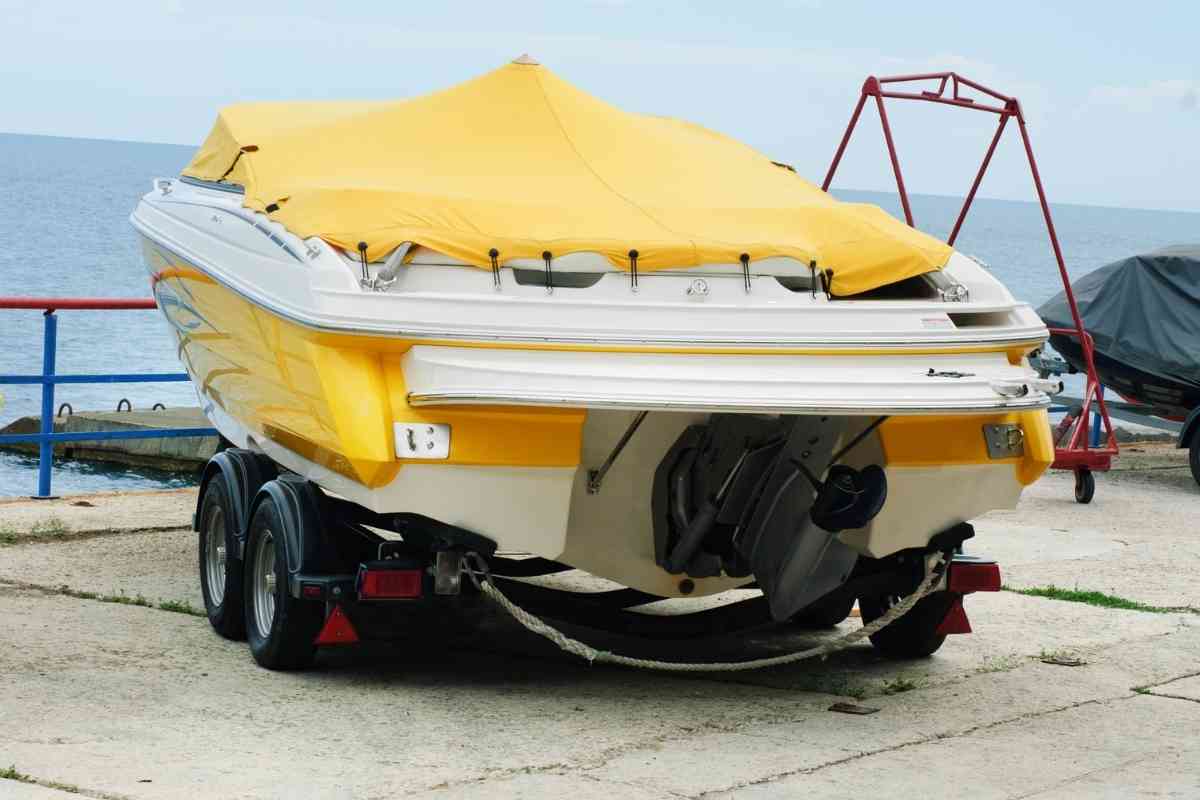 What Happens When You Exceed Towing Capacity? 1 A yellow and white boat sitting in the harbor, an example image for the article on what happens when you exceed towing capacity.