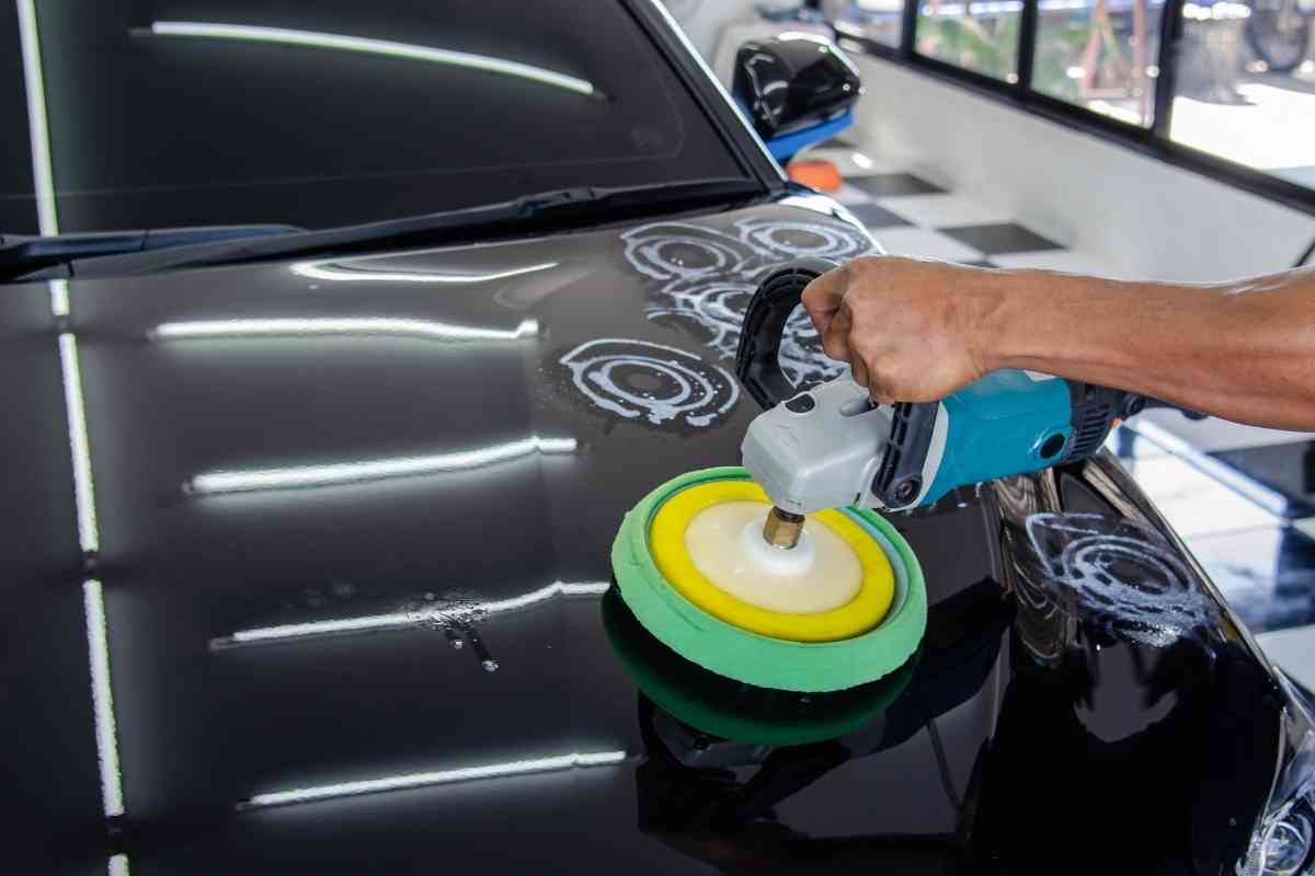 Generic image for best car wax article shows a man polishing a hood