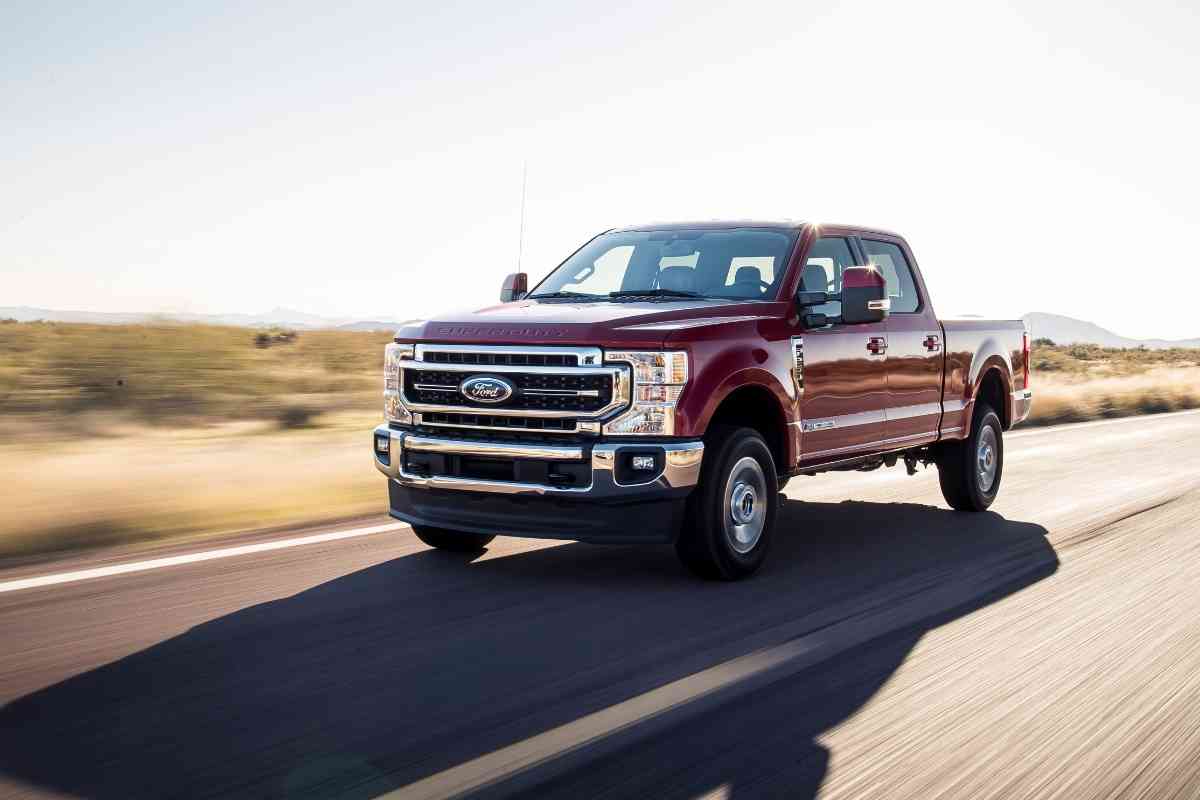 Image for: Ford F250 years to avoid. The image shows a burgundy F250 driving on the highway at speed
