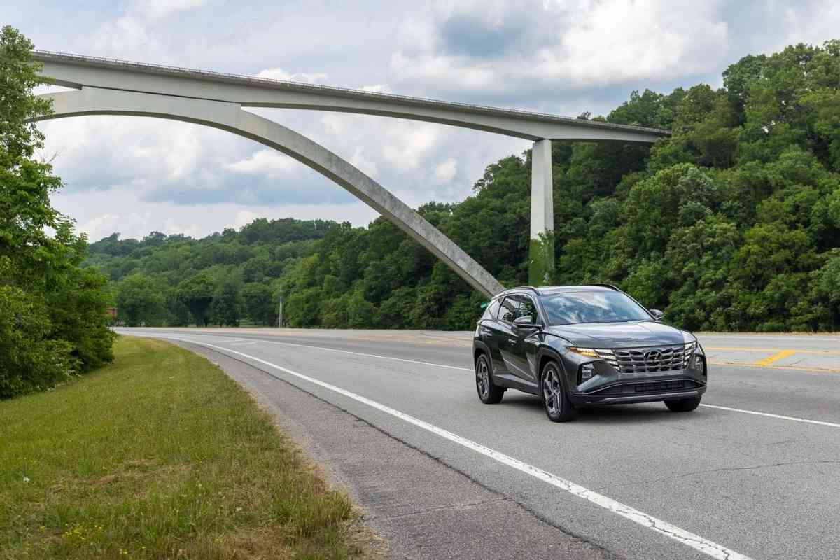 Image shows a dark grey Hyundai Tucson driving under a bridge. The Hyundai Tucson is one of the best used diesel SUVs out there