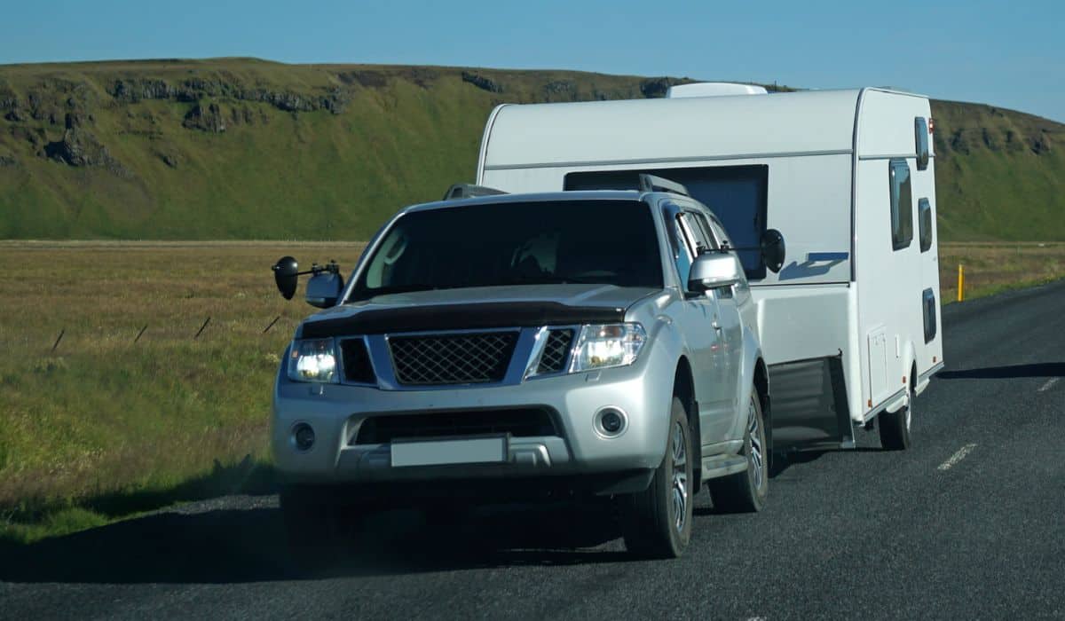 Car towing a trailer on a road in Iceland