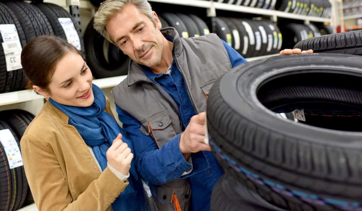 Customer in car store buying tires