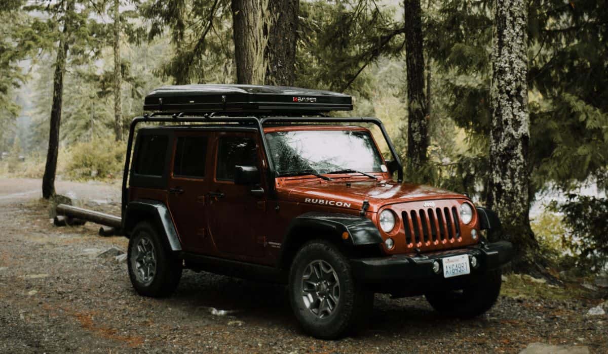 Jeep Wrangler Unlimited with Roof Camper in Pacific Northwest Forest