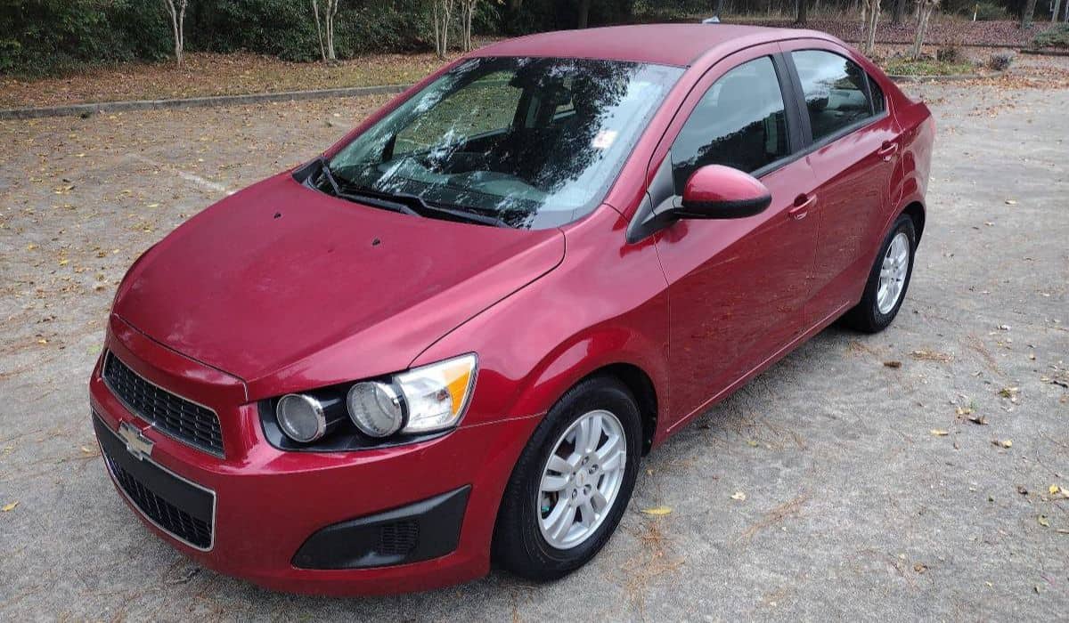 Red Chevy Sonic in a parking lot