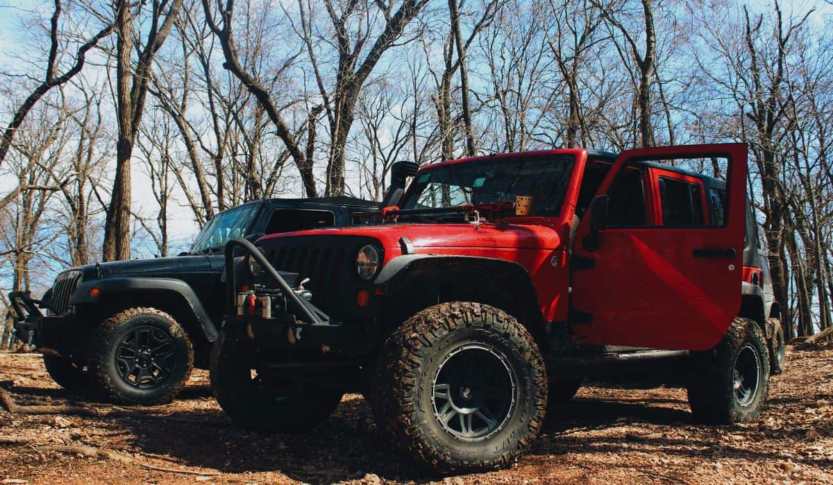 Two jeeps on a dirt trail
