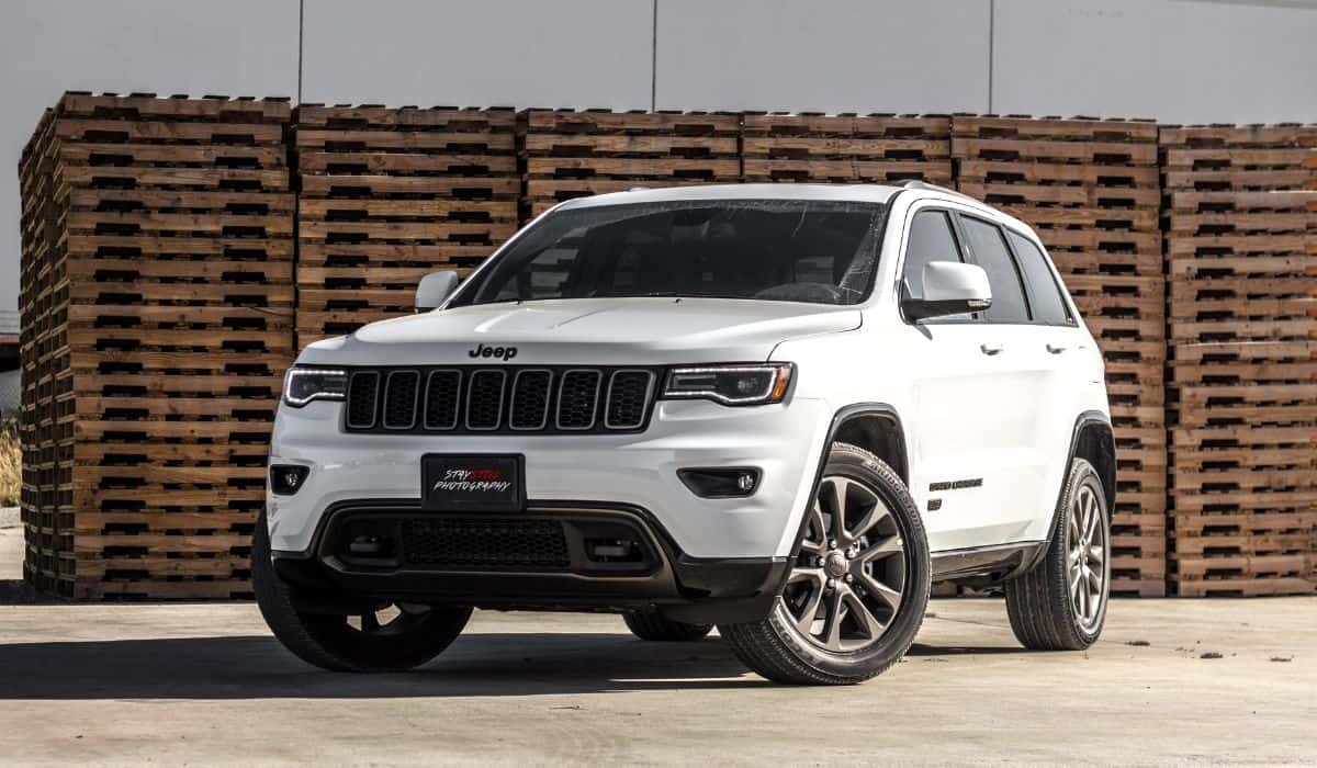 White Jeep Cherokee Suv Near Stacked Brown Pallet Boards