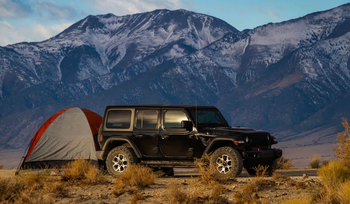A campsite in the Nevada Wilderness with a tent and a Jeep