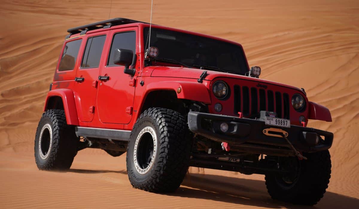 Red and Black Jeep Wrangler on Desert