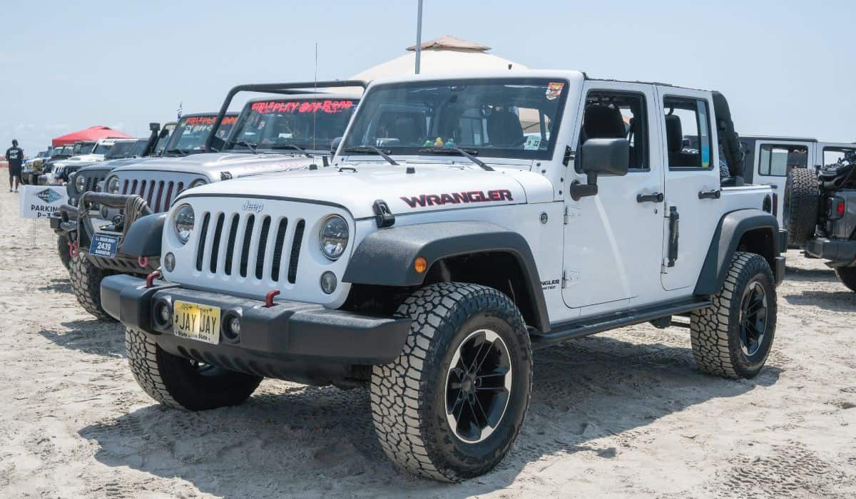 White and Black Jeep Wrangler on Gray Sand