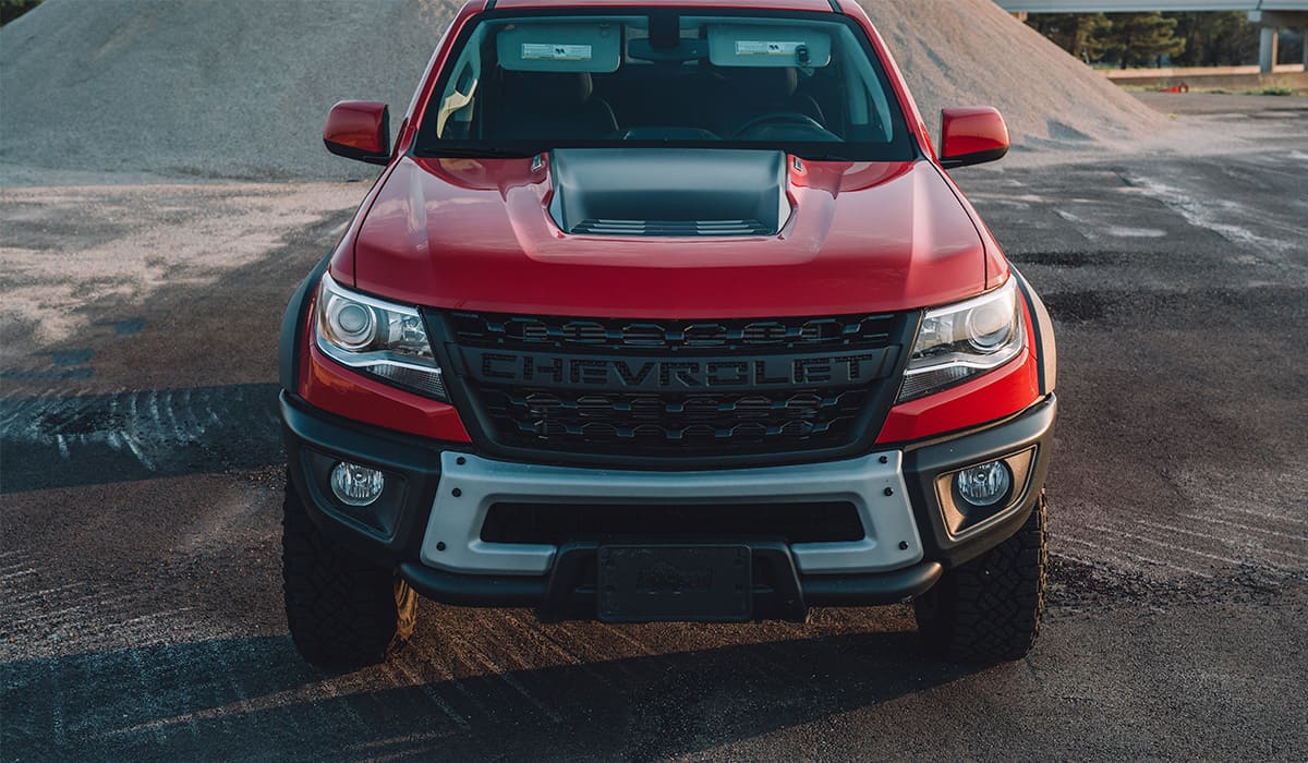 front of a red chevrolet colorado