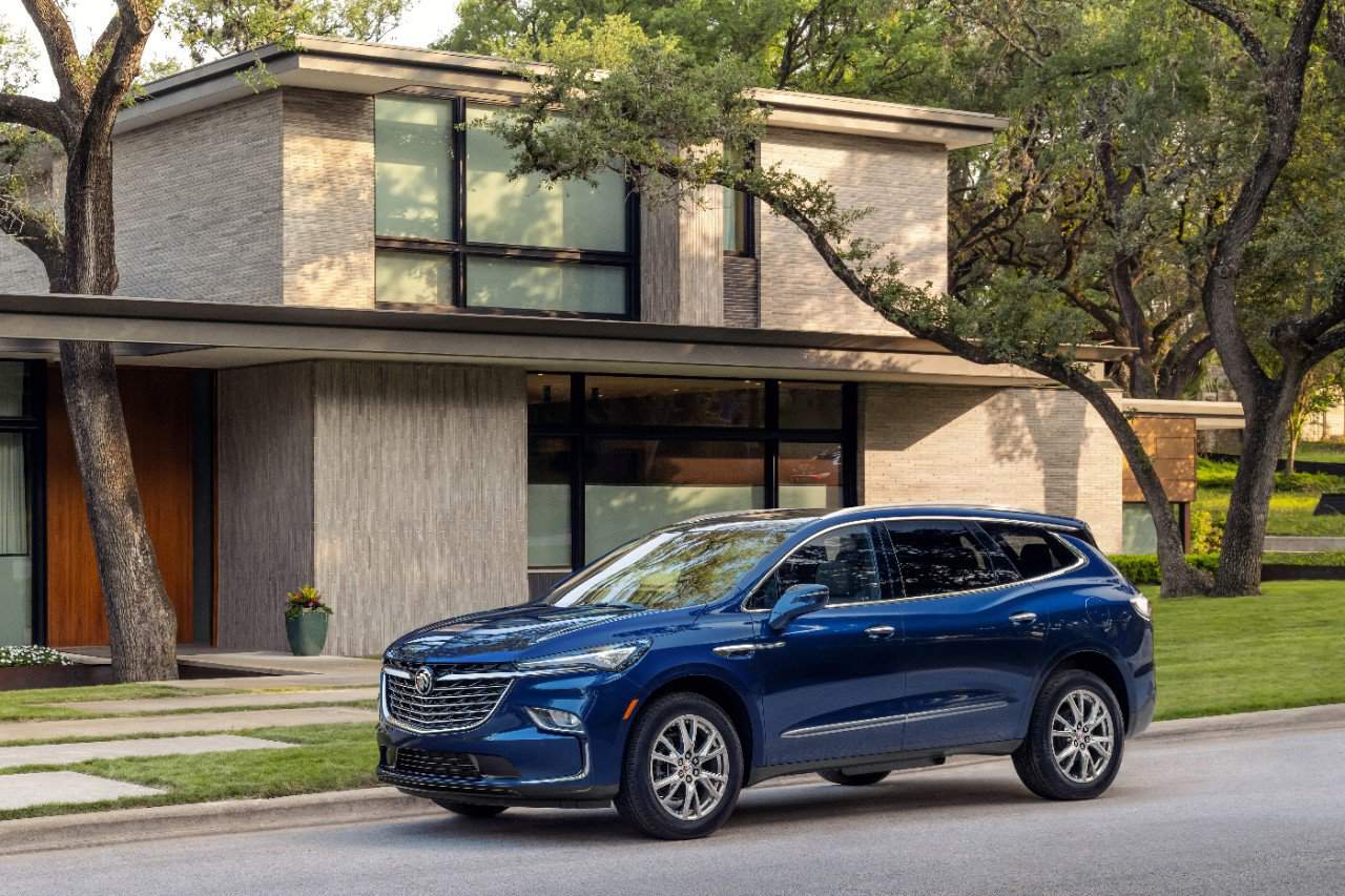 Image for: best used 7-passenger SUV to buy shows a blue buick enclave against a house