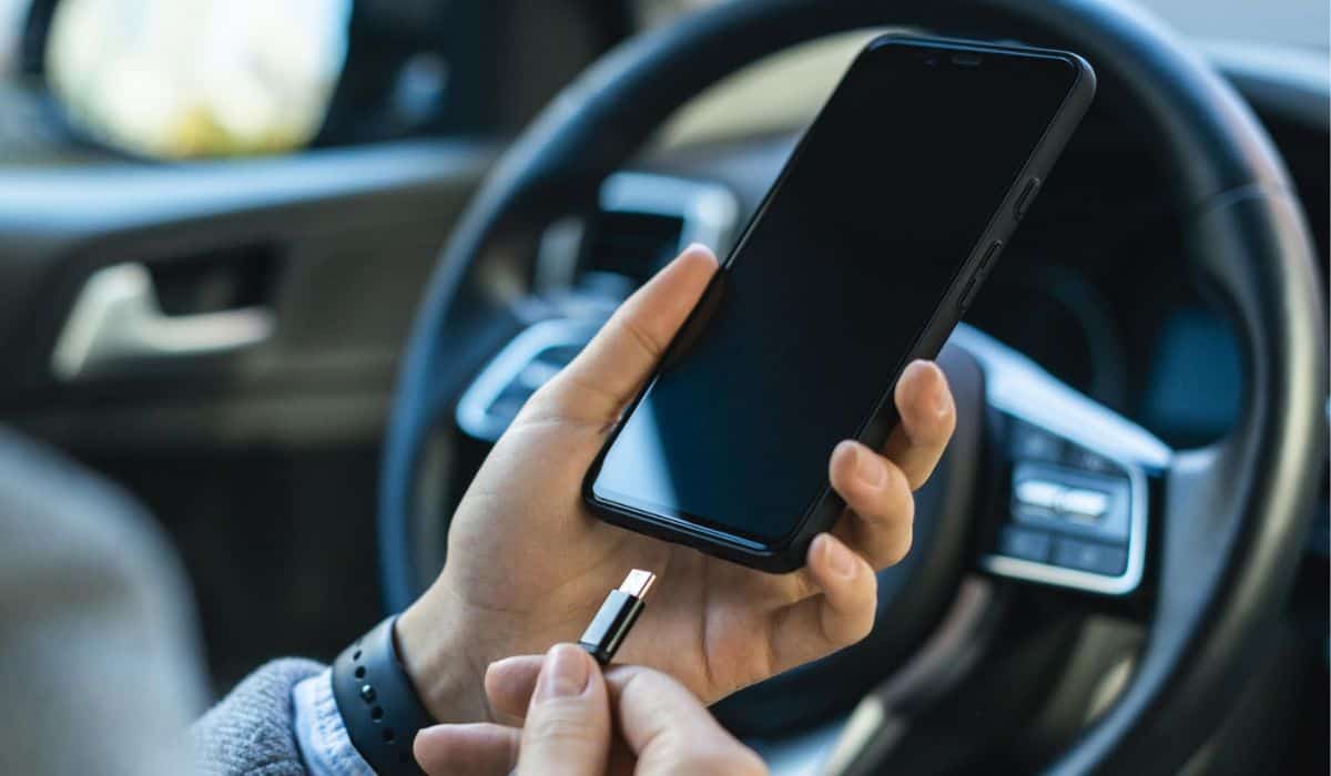 Businesswoman charging her phone car