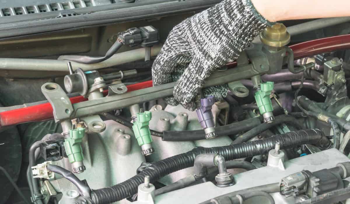 Car mechanic Checking fuel injector system