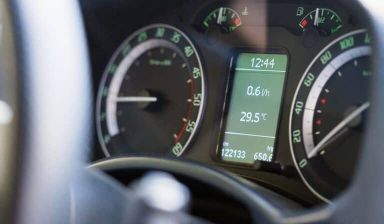 Close up dashboard of a modern car mileage and temperature