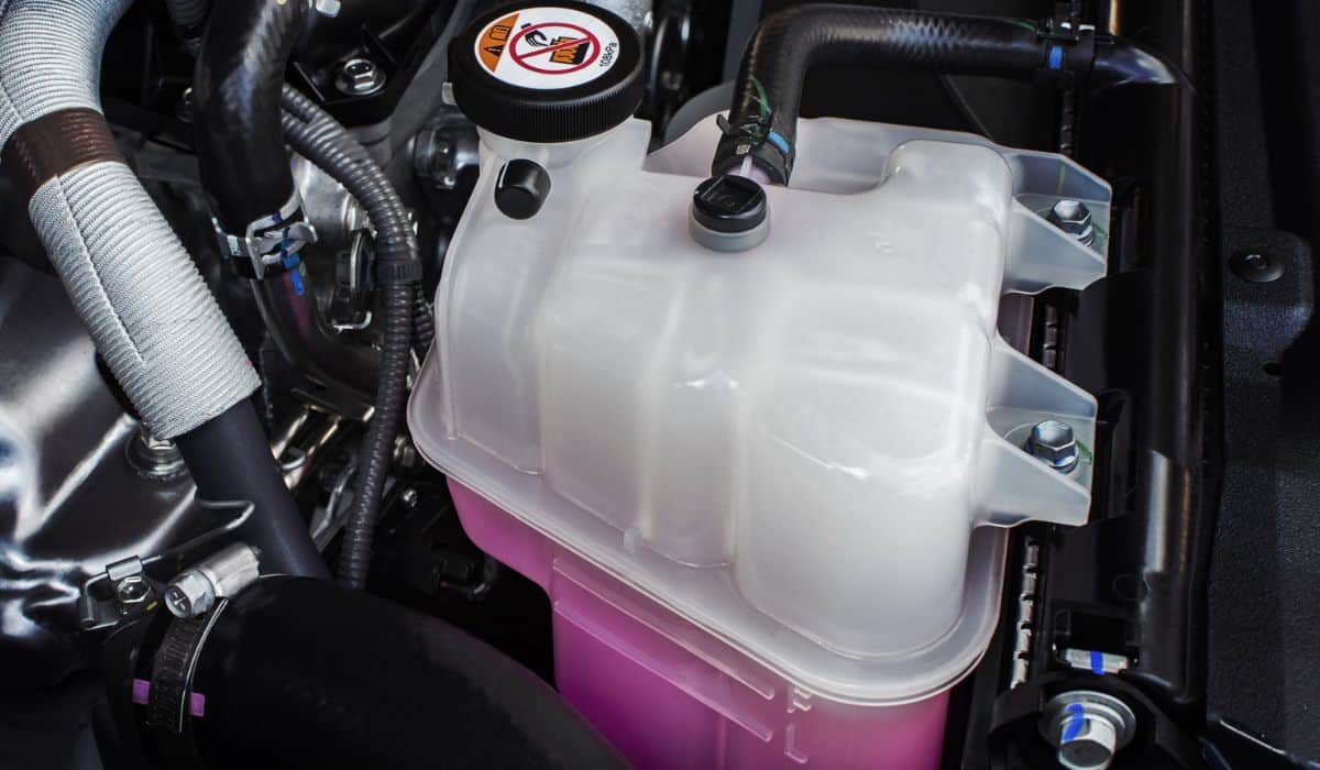 Coolant tank with a pink liquid antifreeze