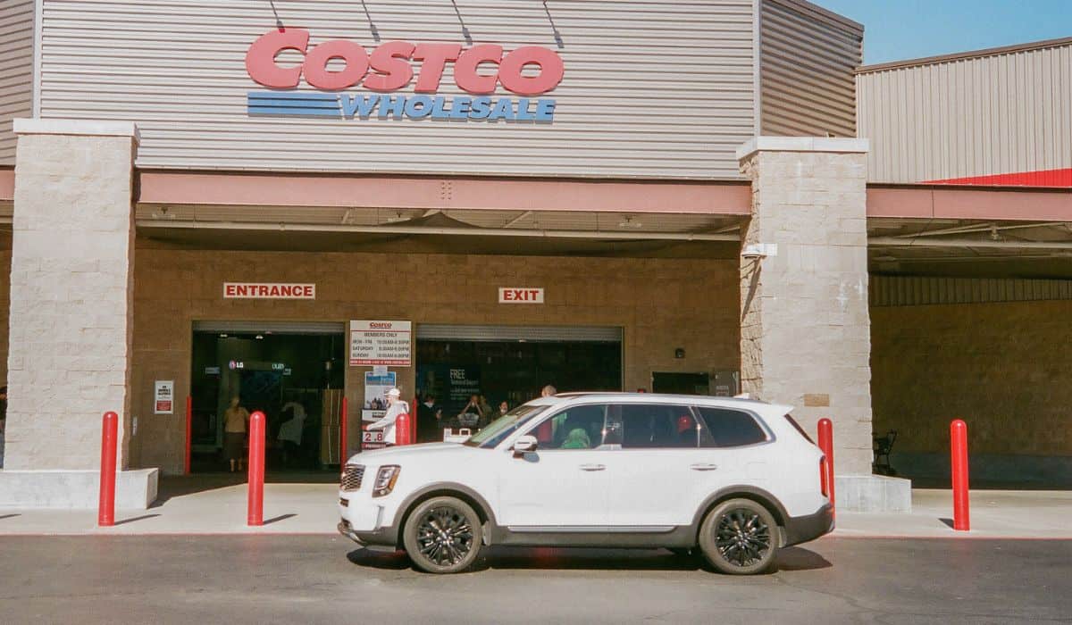 Where does Costco get their gas from? The image shows a white SUV in front of a Costco store