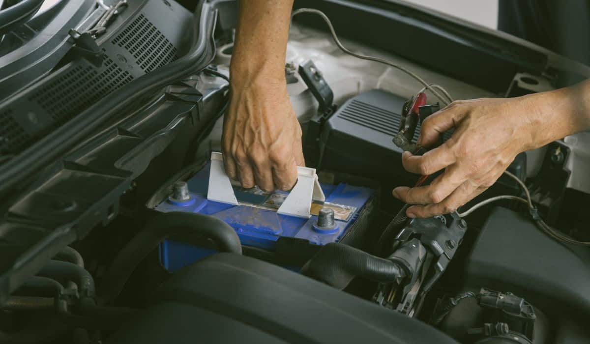 Engine engineer is replacing car battery because car battery is depleted