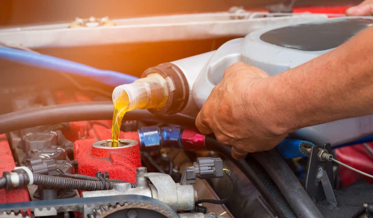 Hand mechanic repairing car, Change the Oil or Pouring fresh oil to car engine