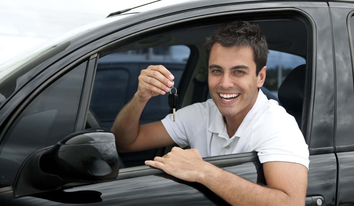 Happy hispanic man in his new car