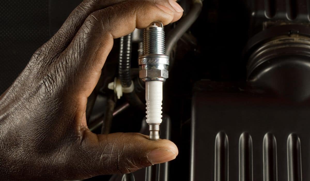 Mechanic holding spark plug