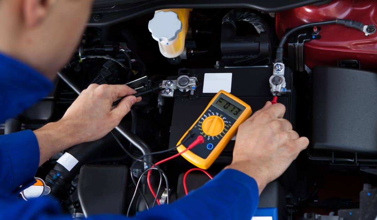 Mechanic testing car battery