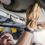 Professional Mechanic Performing Car Catalytic Converter Check