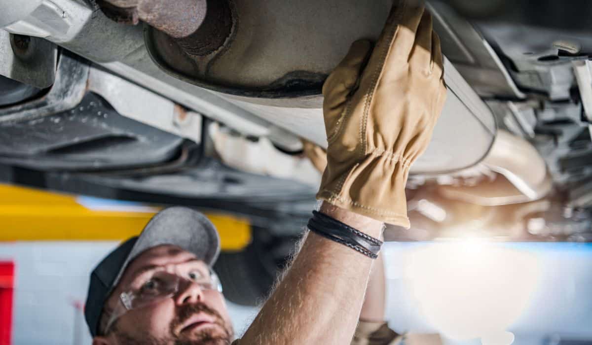 Professional Mechanic Performing Car Catalytic Converter Check