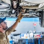 Professional Mechanic Performing Car Undercarriage Inspection