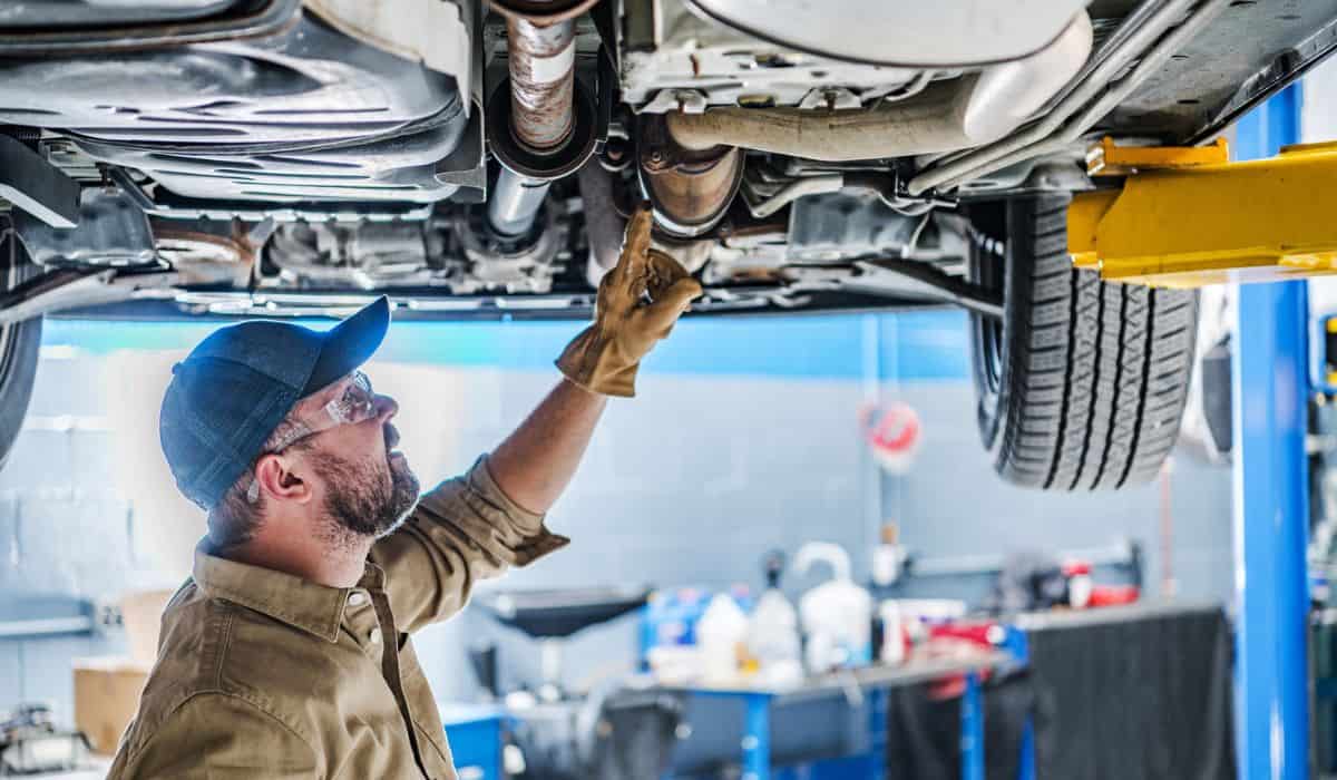 Professional Mechanic Performing Car Undercarriage Inspection