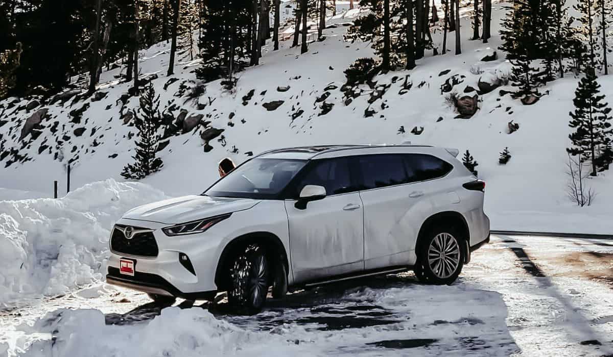 White Suv on Road Covered With Snow