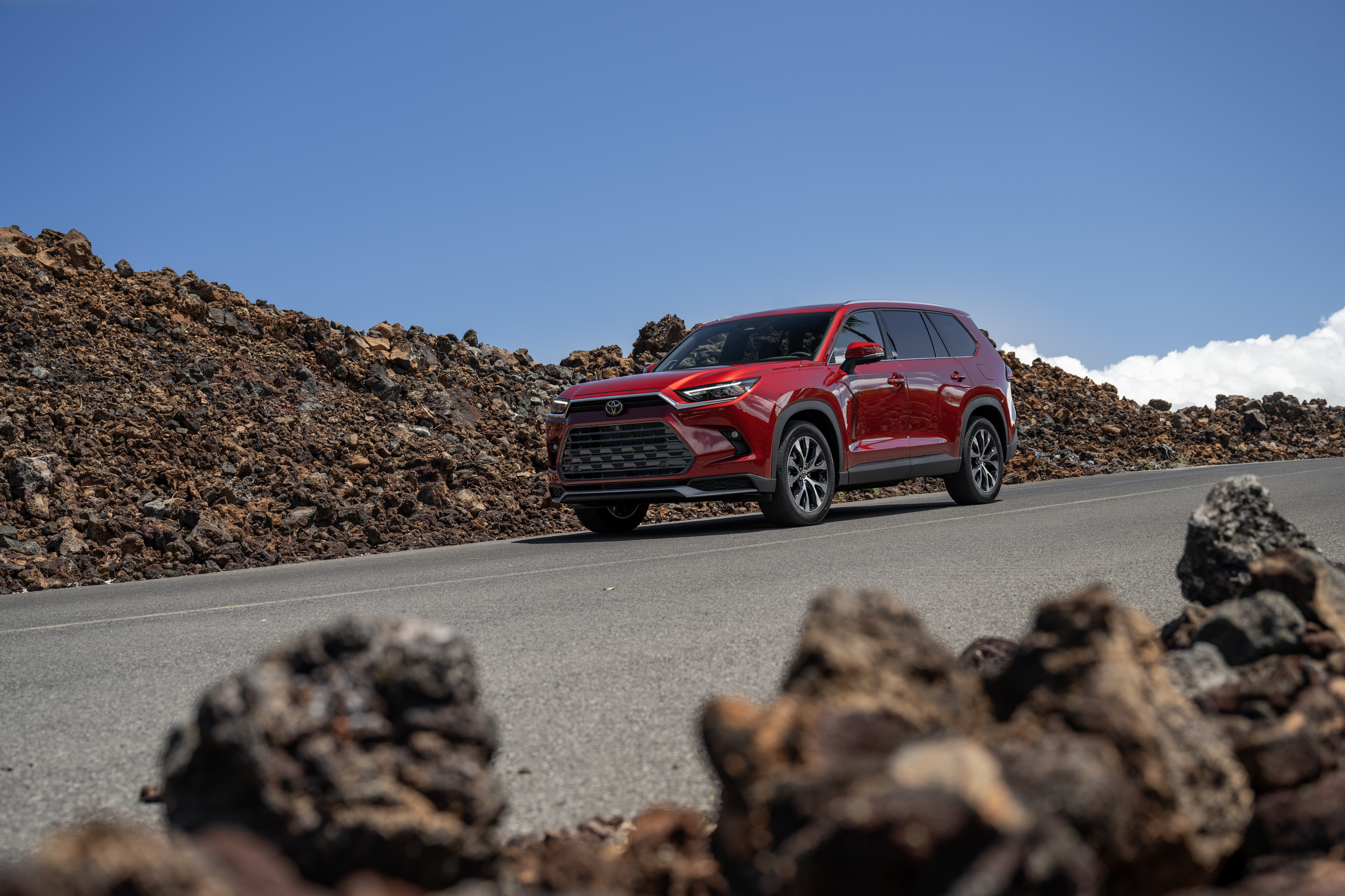 Best and worst years for the Toyota Highlander: image shows a red Toyota Highlander against a rocky background