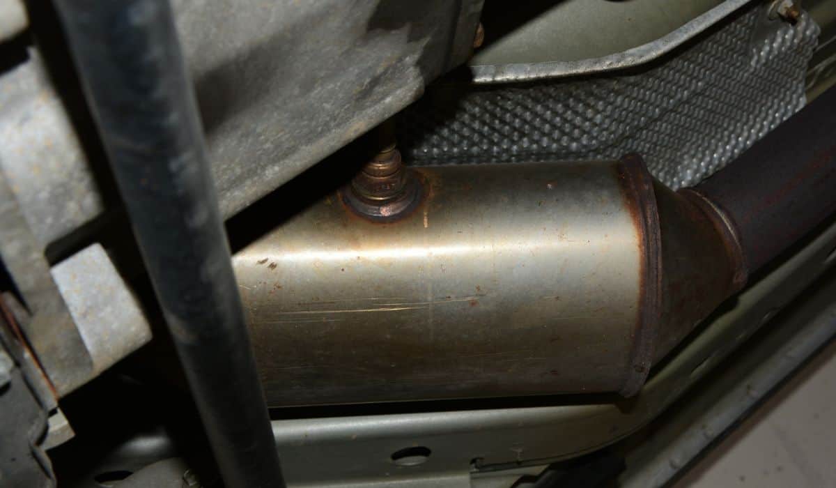 Catalytic Converted with O2 Sensor Under Car: image for "can you trade in a car without a catalytic converter"
