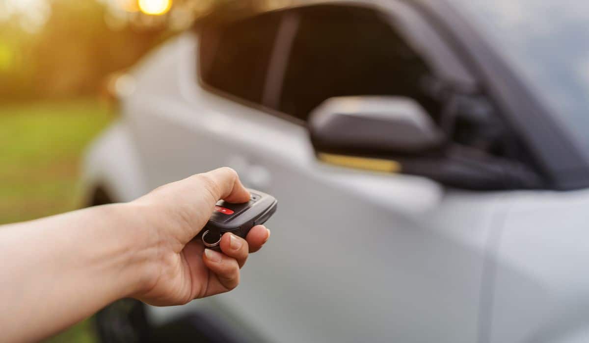 Hand using remote key to unlocked car