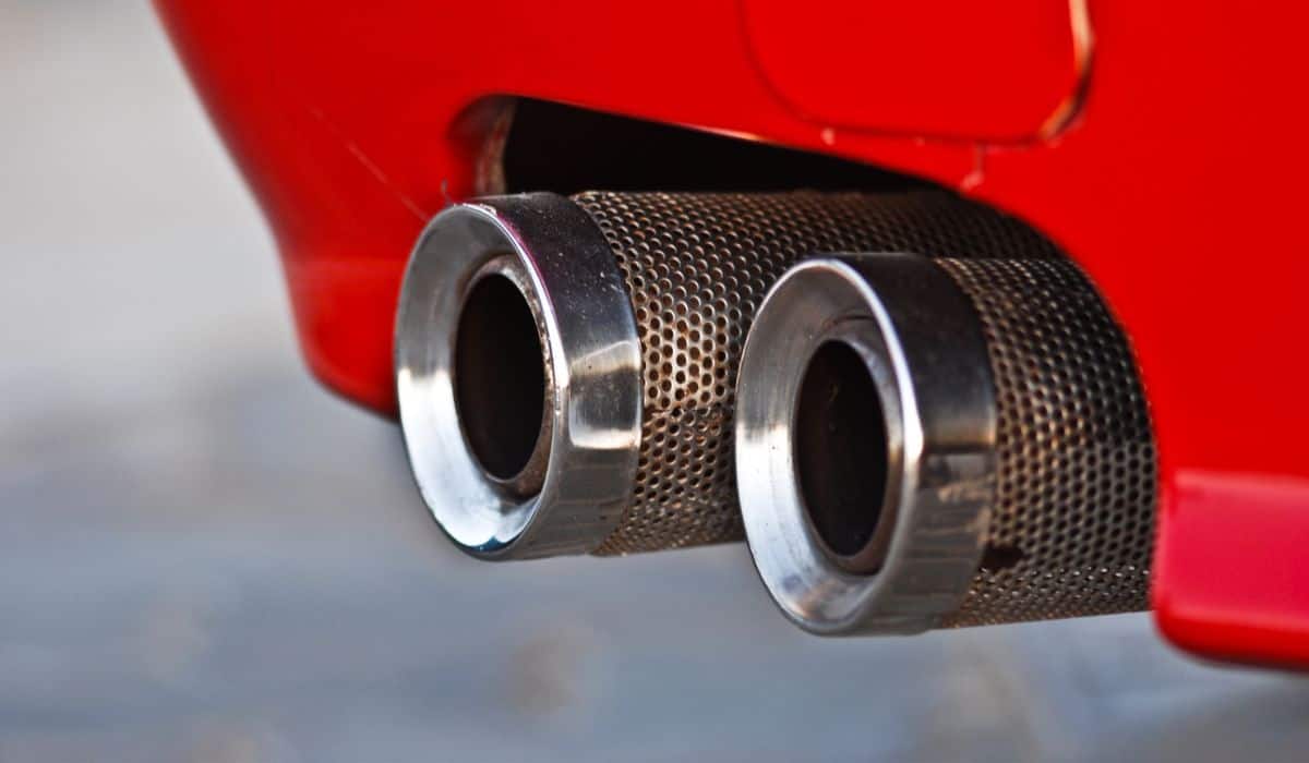 Red classic sport car exhaust close up