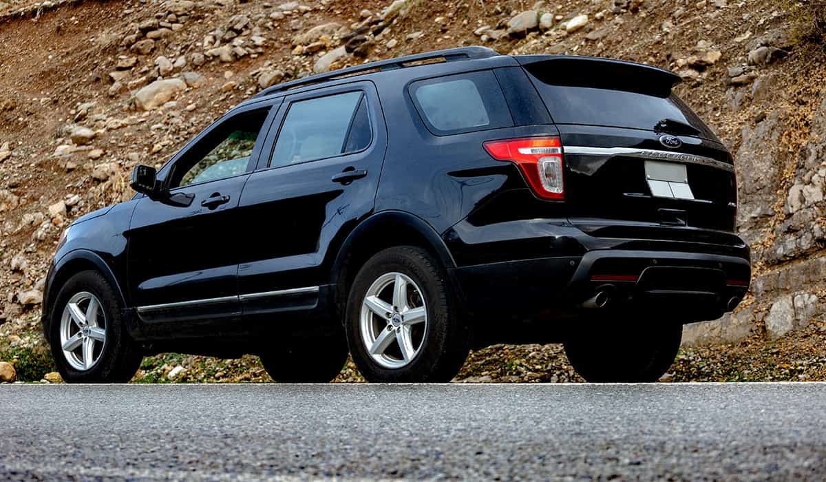 Black Ford Explorer parked on the side of a road