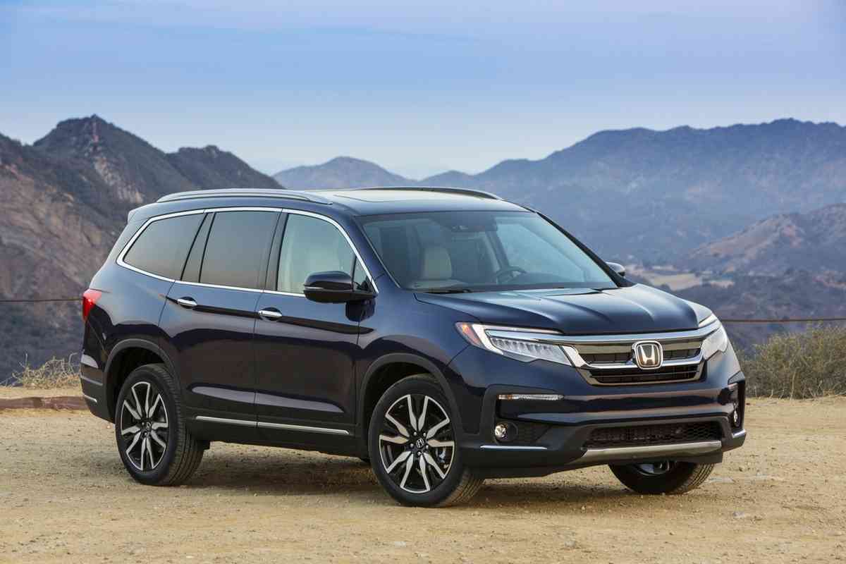 What SUV can fit 4 car seats? The Honda Pilot is an excellent option for this. The image shows a black Honda Pilot against a mountainous terrain
