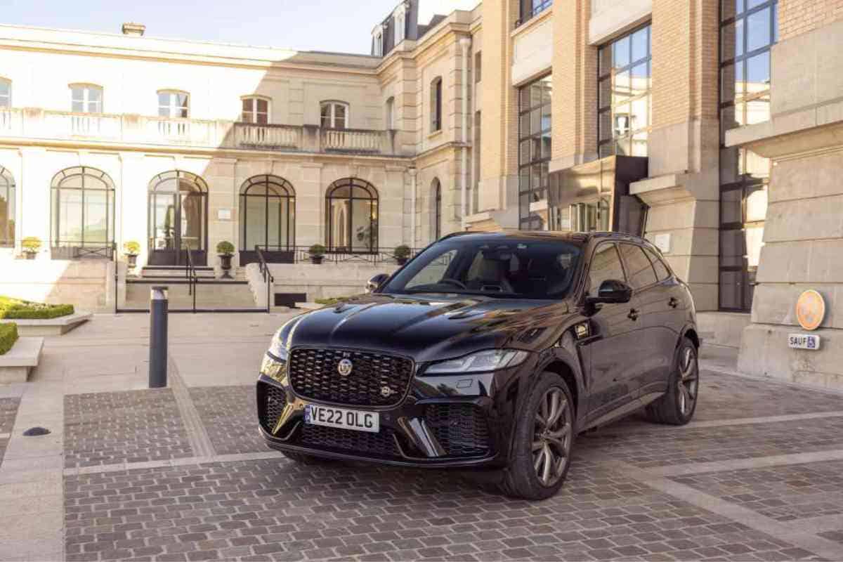 What are the best years for the Jaguar F-Pace? Image shows a black jaguar F-pace against a vintage building