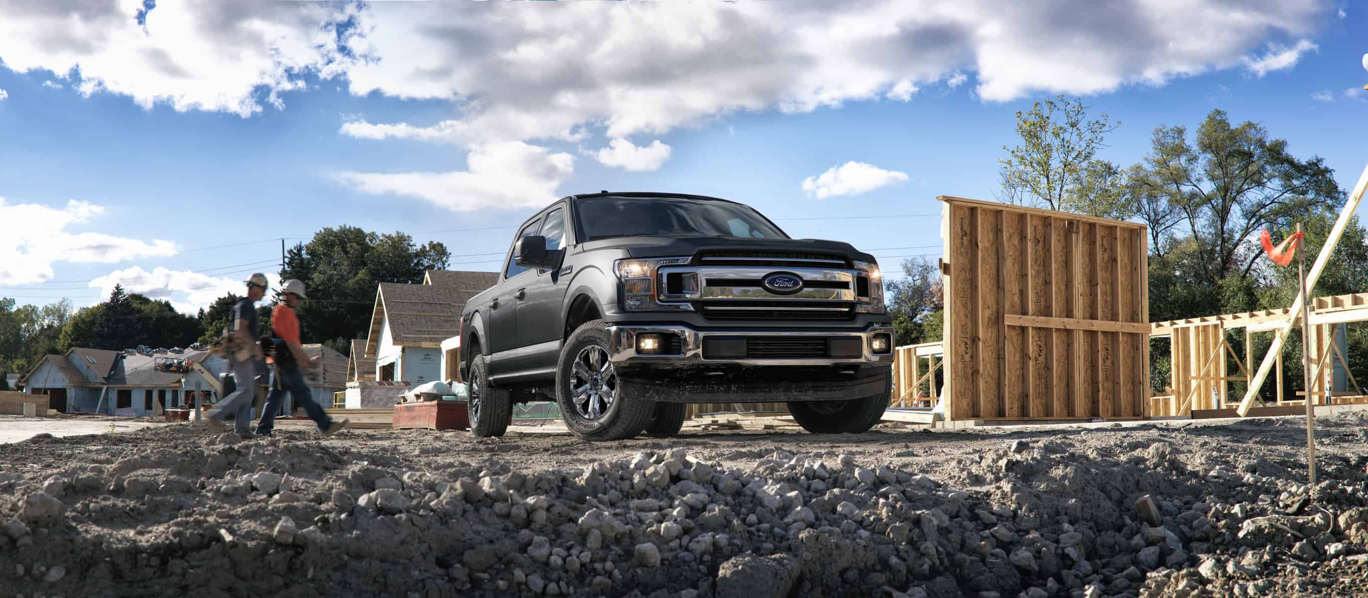 Is The Ford F-150 America's Best-Selling Truck? A generic image shows a gray F-150 on top of gravel with two workers walking behind it
