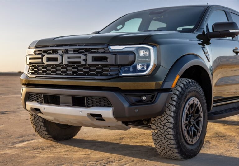 photo of the front of a Ford Ranger Raptor sitting on sand