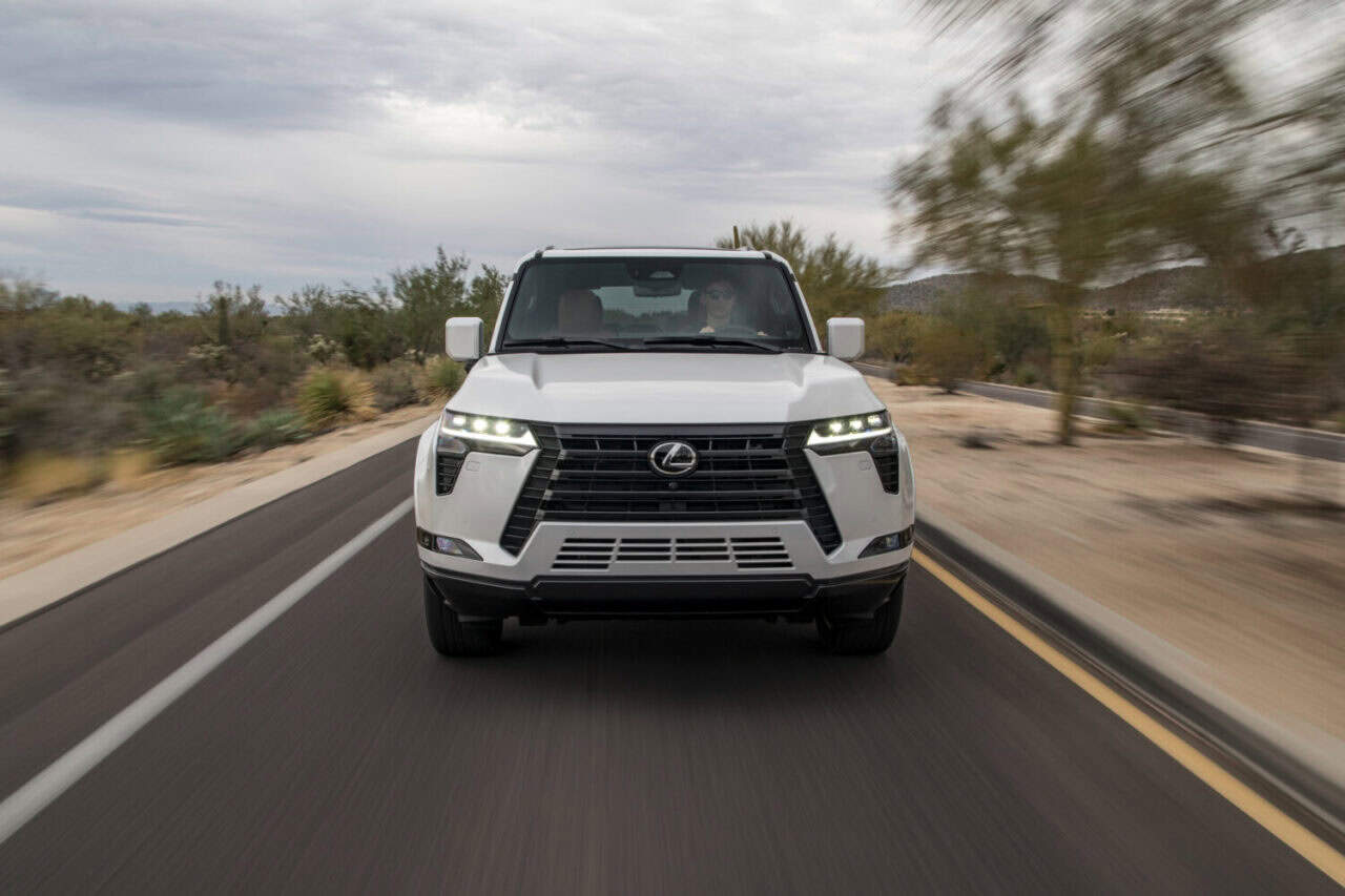 2025 Lexus GX 550 in white driving down the road